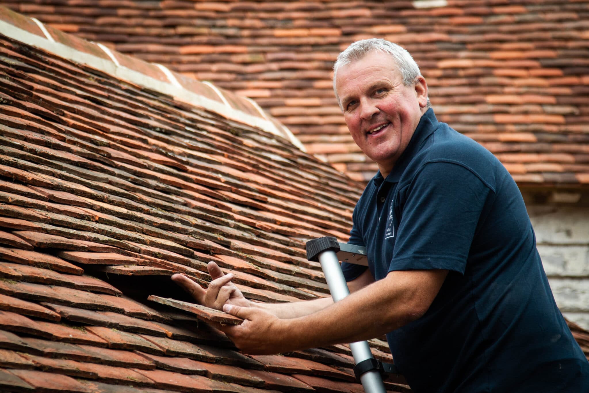 Local Craftsman Repairing Tile Roof