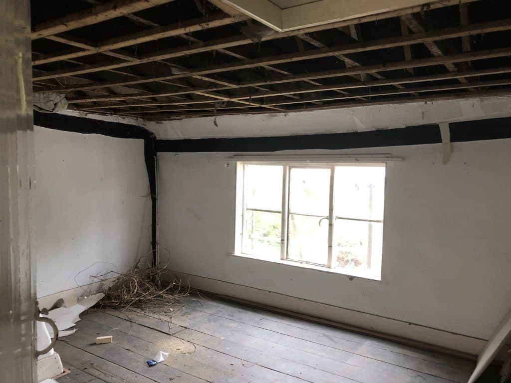 Upstairs bedroom before restoration work at Tanners Farmhouse